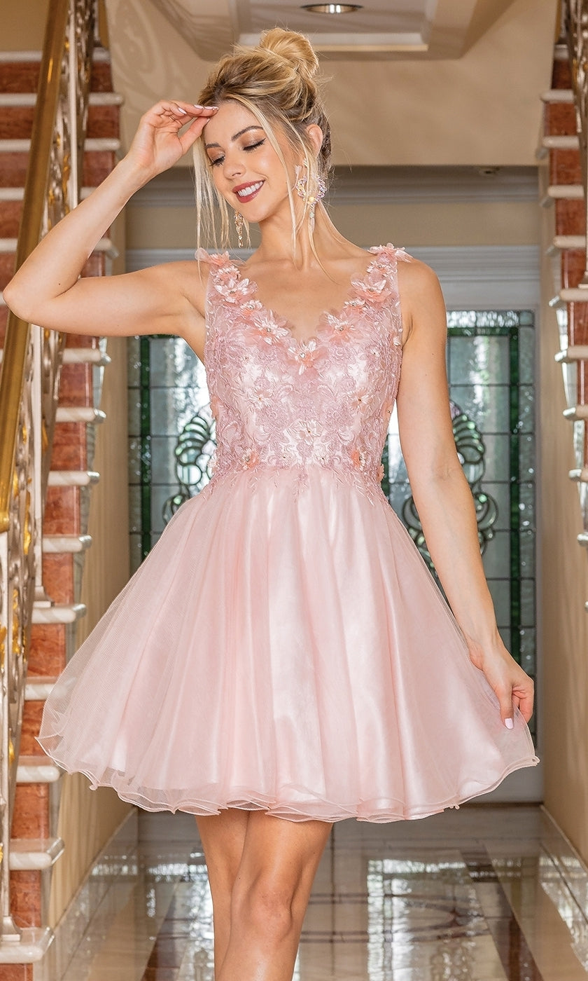A woman smiles indoors, holding the skirt of her light pink Flower-Bodice Sleeveless Short Hoco Dress 3297, featuring floral lace details. This budget-friendly party dress under $100 is ideal for your next special occasion.